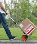 Person using Folding Hand Truck And Dolly For Easy Haul, 275 Lb Capacity Aluminum Cart With Telescoping Handle on a walkway