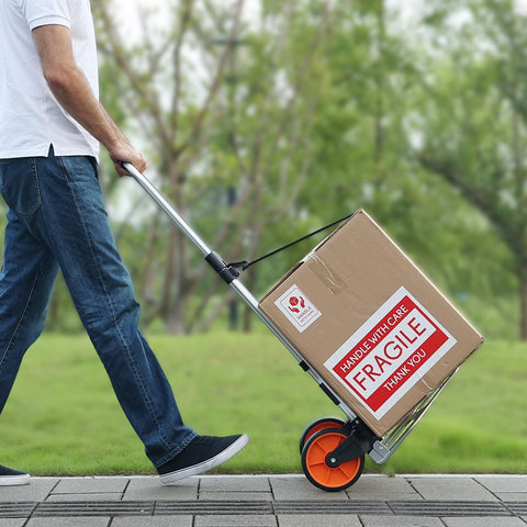 Person using Folding Hand Truck And Dolly For Easy Haul, 275 Lb Capacity Aluminum Cart With Telescoping Handle on a walkway
