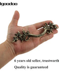 Hand holding Five Piece Antique Bronze Drawer Handle Set 6.61 Inch Vintage Cabinet Pulls for furniture with floral design