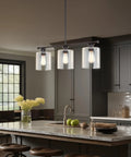Dope Three Light Modern Industrial Farmhouse Kitchen Island Pendant Lighting With Clear Glass Cylinder Shades shown over island