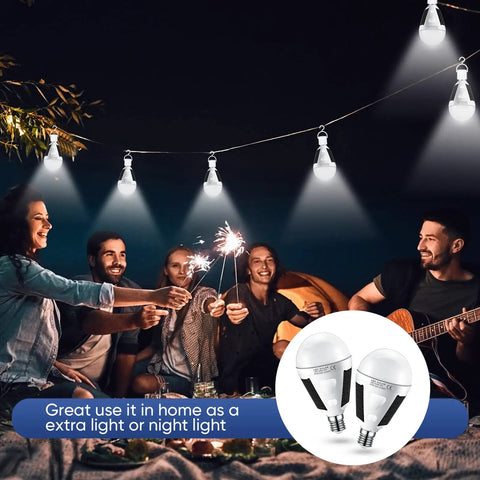 Group camping at night using 4 Pack Solar Rechargeable LED Light Bulbs 12W 6500K Portable Emergency Lighting for outdoor illumination.