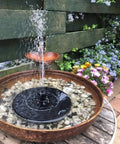 Solar Powered Bird Bath Fountain Pump Kit With 4 Nozzle Heads, Quiet Submersible Water Pump in garden setting