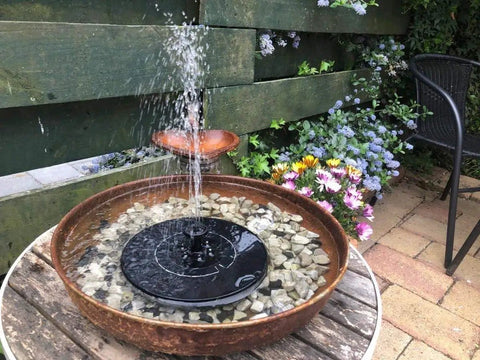 Solar Powered Bird Bath Fountain Pump Kit With 4 Nozzle Heads, Quiet Submersible Water Pump in garden setting