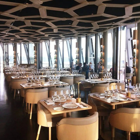 Elegant restaurant setting with table lamps, featuring 2 Pack Cordless Rechargeable LED Table Lamps With 5000mAh Battery No Fuss Portable Battery Powered Desk Lights For Restaurant And Outdoor Use Up To 40 Hours Runtime 3 Level Stepless Dimming Gold.