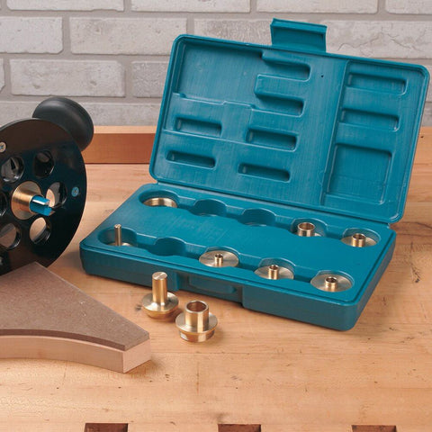 11-Piece Router Guide Bushing Kit for Templates, Patterns, Or Jigs with storage case and brass bushings on wooden table