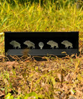 Portable Full Metal Quad Hog Target Set for Pellet and BB Guns with four hog silhouettes and center ring in grass.