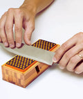 Hands sharpening a knife on a Diamond Knife Sharpener Set With Grits 400 And 1200 Built In Angle Guides Monocrystalline Diamond Stones