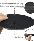 Hands holding a 5 Inch Hook And Loop Replacement Sanding Pad With 8 Holes And 3 Screw Holes For Fast No Fuss Orbit Sanding On 5 Inch Sanders Compatible With BO5010 BO5030K BO5031K BO5041K Durable Dust Holes Pad showing uniform dense hook and loop bottom and soft rubber edge.