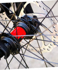 Close-up of Bombproof Mechanical Disc Brake Rotor Kit For Mountain Bike featuring Front And Rear 160 Mm Silver Rotors on wheel hub.