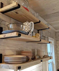Knockout Heavy Duty Shelf Brackets For Floating Shelves Built Like A Tank With Solid As A Rock Iron Design Slick Industrial Wall Mount Brackets Black supporting wooden shelves with dishes.