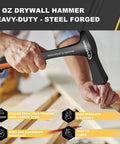 36 Oz Rock Pick Hammer Heavy Duty Masonry and Bricklayer Tool With Comfortable Rubber Grip in hand on wooden surface