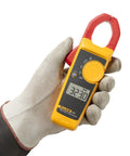 Hand holding Pro Grade Clamp Meter For Electricians With True RMS Readings, Measures AC Current To 400 A, AC And DC Voltage