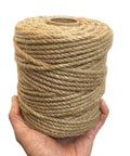 Person holding Heavy Duty 5mm Jute Twine 328 Feet Braided Rope for DIY Artwork and Home Decor, in a roll, natural color.