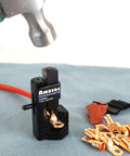 Heavy Duty Hammer Lug Crimper For 8 AWG To Four O Wire Gauge And 0000 Battery Cables with hammer above, on light surface