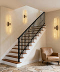 Natural Alabaster Brass Wall Sconce, Modern Indoor Bathroom Vanity Light illuminating staircase wall, featuring bronze finish and alabaster shades.