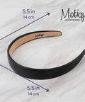 One Inch Vegan Leather Headband For Women Non Slip Hair Band Black on marble surface measuring 5.5 inches.
