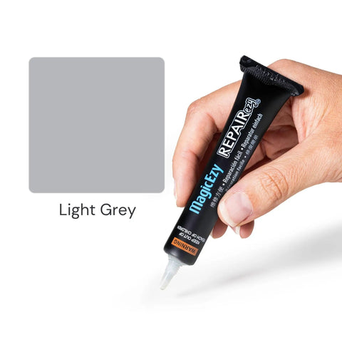 Hand holding tube of Light Gray Tile Repair Filler And Touch Up Paint For Porcelain Tiles And More, Ultra Durable Nanotech Formula