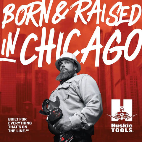 Man with beard holding Beast 32mm Manual Hydraulic Cutter against Chicago skyline, wearing work attire.