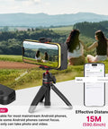 Grip Holder For Smartphone With Remote Shutter Tripod Mount And Removable Ring Light in landscape shooting mode with two people outdoors.