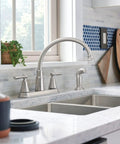 Hutchinson Spot Resist Stainless 2-Handle High Arc Kitchen Faucet With Side Sprayer in modern kitchen setting