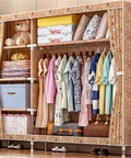 Large Capacity Portable Wardrobe Closet With Washable Oxford Fabric Cover And Heavy Duty Hanging Rods For Real Clothing Storage displayed with clothes.