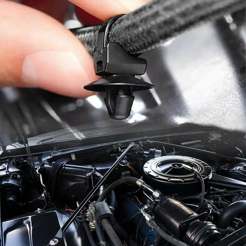 Close-up of a push-in clamp from the 130Pcs Automotive Cable Ties And Wire Loom Kit in a car engine bay.