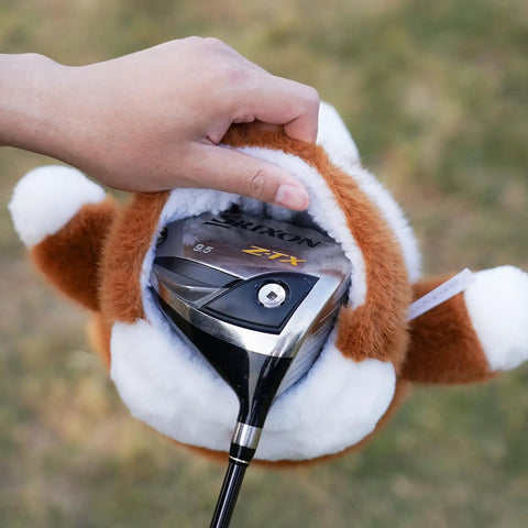 Hand placing a golf driver inside Corgi Driver Headcover Soft Plush Golf Club Cover Brown And White Totally Cute Corgi Design With Realistic Face And Paws Durable Material For Golfers Great Gift For Any Golf Enthusiast