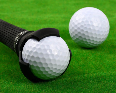 Three Prong Golf Ball Retriever Tool For Putter And Golf Clubs Universal Fit holding a golf ball on green grass
