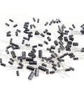 Through Hole Electrolytic Capacitor Assortment Kit, 120 Pcs Total, 12 Types scattered on a surface, showing radial leads.