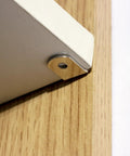 Solid As A Rock Metal Shelf Pegs 1 4 Inch L shaped support bracket installed on a wooden cabinet shelf.