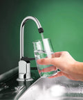 Top Shelf One Handle Low Arc Chrome Faucet For Countertop With Lead Free Drinking Water Flow and Slick Spot Resistant Coating pours water into a glass.