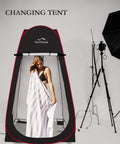 Instant Pop Up Privacy Tent 3.9x3.9x6.9 Ft Large Portable Changing Room with model inside, black with red accents, in studio.