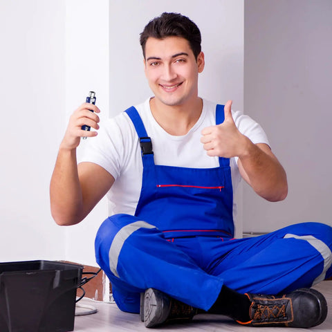 Technician holding Two Pack Electric Control Cabinet Keys Set With Double Joint Cabinet Panel Keys, seated in blue workwear.