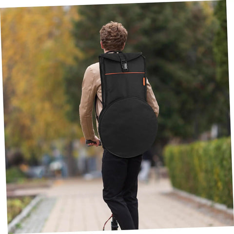 A person riding a scooter with a Heavy Duty Black Drum Bag Made For Open Road Rhythms on their back, showcasing its sleek design.