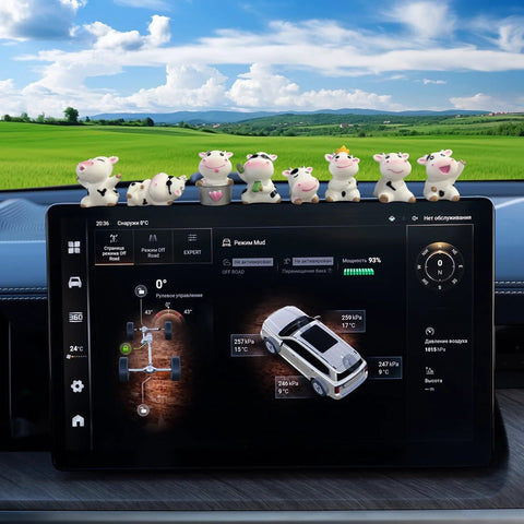 Front view: Amazon 8-piece cow dashboard ornaments on car dash above the touchscreen display