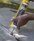 Straightforward Concrete Crack Filler Gray Sealant For Driveways Patios And Slabs Water Based Acrylic Latex Formula applied to concrete crack.