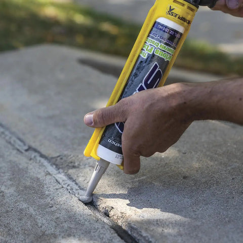 Straightforward Concrete Crack Filler Gray Sealant For Driveways Patios And Slabs Water Based Acrylic Latex Formula applied to concrete crack.