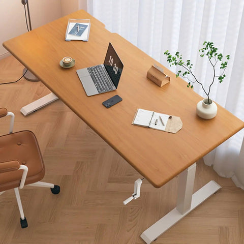 Get Your Posture Locked In With This Cherry Wood Manual Standing Desk And Straight Up Game Changing Crank Lift Mechanism For Home Offices Or Bedrooms Boasting A Foldable Handle And Massive Work Surface, featuring a spacious wooden top, a laptop, and a manual crank.
