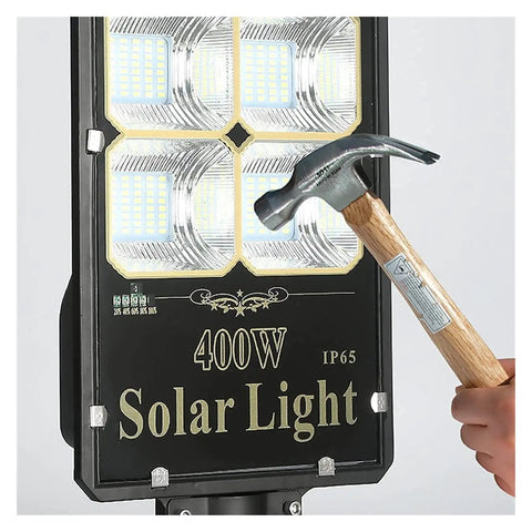 Top Tier Outdoor Solar Flood Light For Yard And Patio Security IP67 Waterproof Motion Detection Dusk To Dawn aviation aluminum build being installed with a hammer.