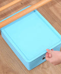 Stainless Steel Furniture Roller With Adhesive Sliders For Heavy Load Moving Washer Dryer Machine And Couch Glide Home Essentials on blue storage box.