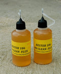 Two bottles of Kester 186 No Clean Flux for electronics soldering on a concrete surface.