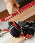 Craftsman using 15 Piece Aluminum Setup Blocks With 6061 T651 Precision Height And Depth Gauge System For Router Table And Table Saw Built For Shop Pros Pro Grade Ultra Durable Workshop Grade Accuracy Plus Or Minus 0.001 Inch while measuring wood with a ruler.