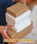 Person holding stacked Bulk 300 Pack Small Shipping Boxes 6 X 4 X 1.5 Inches Corrugated Kraft Mailers For Jewelry Cosmetics Soap And Craft Projects