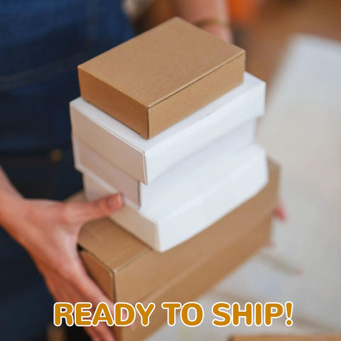 Person holding stacked Bulk 300 Pack Small Shipping Boxes 6 X 4 X 1.5 Inches Corrugated Kraft Mailers For Jewelry Cosmetics Soap And Craft Projects