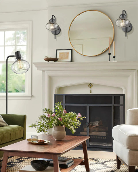 Rustic Wall Sconces Set Of 2 With Hand Blown Bubble Glass Shades on a white wall above a fireplace, modern farmhouse decor style.