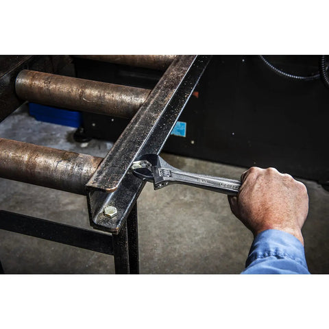 Person using 12 Inch Adjustable Wrench With Laser Etched SAE And Metric Scales, Large Knurl For Quick, Smooth Jaw Adjustment, Chrome Finish Carded AC212VS For Home, Garage And Everyday DIY Projects to tighten a bolt on metal frame.