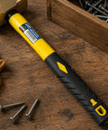 Two Pound Brass Head Sledge Hammer With Fiberglass Handle, Workhorse Impact Tool on wooden surface with screws