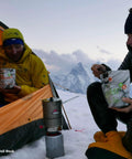 Hikers using Reactor Windproof Camping Stove System With 1.0L Pot Crazy Fast Boil Time For Backcountry Cooking Ideal For Backpacking And Hiking 2024 Version Self Contained All In One Stove Kit in snowy mountain setting.