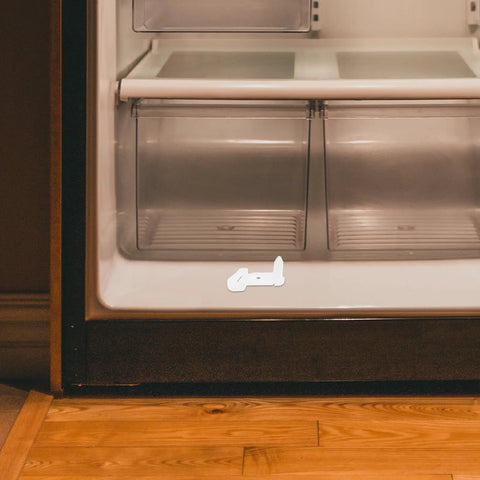 Awesome Fridge Door Stop Latch That Kills Noise And Stops Bumps With A Tough Plastic Clip on a refrigerator, highlighted for use.