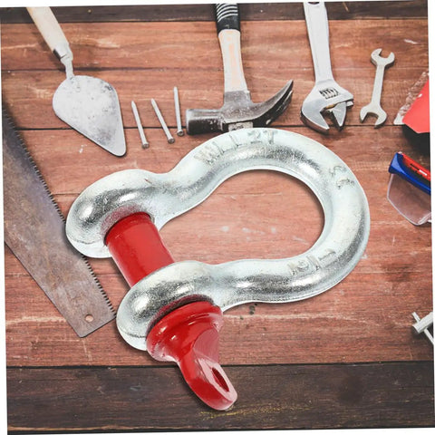 Heavy Duty Galvanized Steel Lifting Shackles Two Pack Iron Strong Hardware Built Tough For Truck Towing Off Road Recovery Quick Release Pin Heavy Load Haulin Operations on wooden surface with tools around.